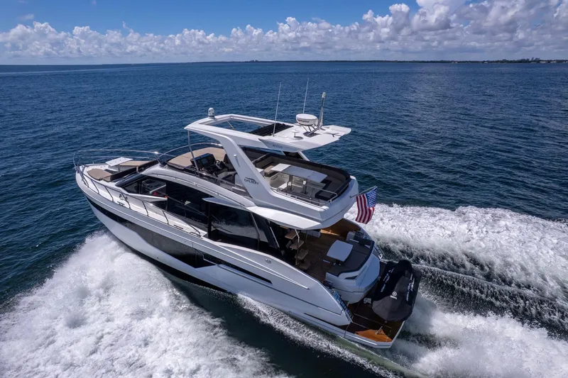 Slide: The Image of 2021 Galeon 500 Fly yacht cruising on open sea under clear skies. - 0