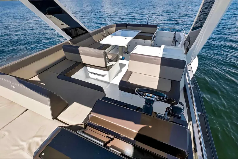 Slide: The Image of 2021 Galeon 500 Fly yacht interior with spacious seating and helm, overlooking the water. - 37