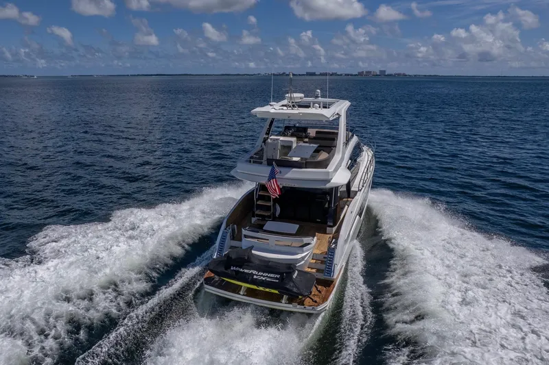 Slide: The Image of 2021 Galeon 500 Fly yacht cruising on open water under a clear sky. - 6