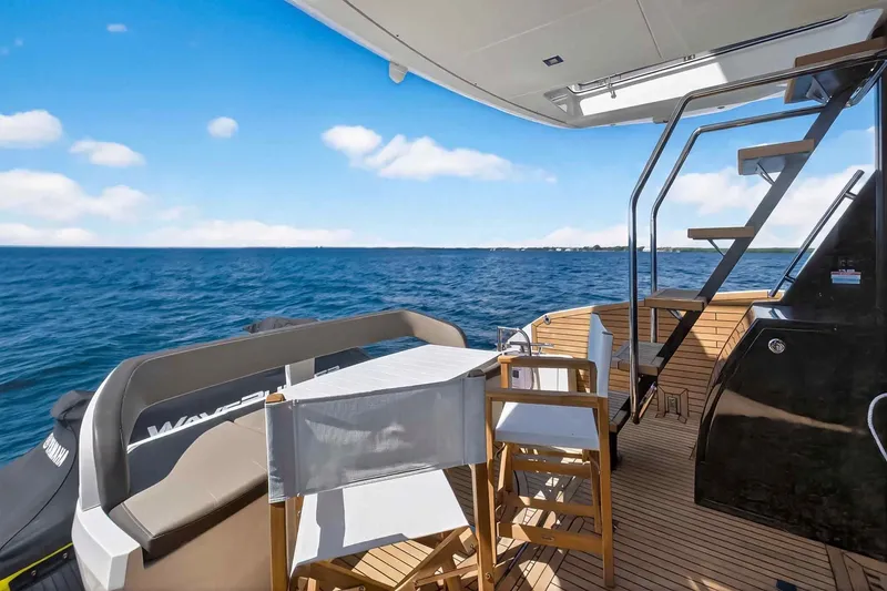 Slide: The Image of Luxury Galeon 500 Fly yacht deck with ocean view, featuring elegant seating and stairs, 2021 model. - 22