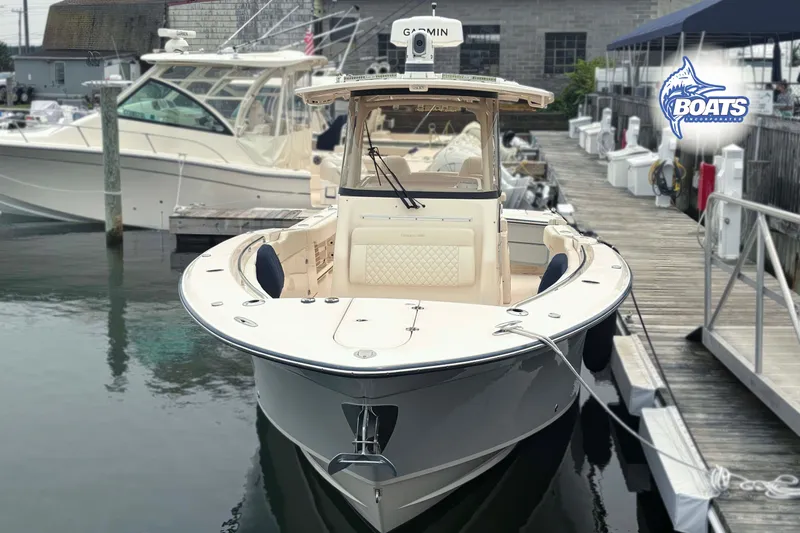 Slide: The Image of 2024 Grady-White Canyon 306 boat docked at marina, showcasing sleek design and advanced features. - 3