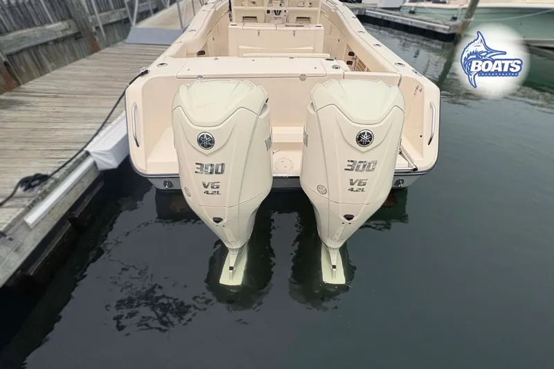 Slide: The Image of 2024 Grady-White Canyon 306 boat with twin Yamaha 300 V6 engines docked at marina. - 12
