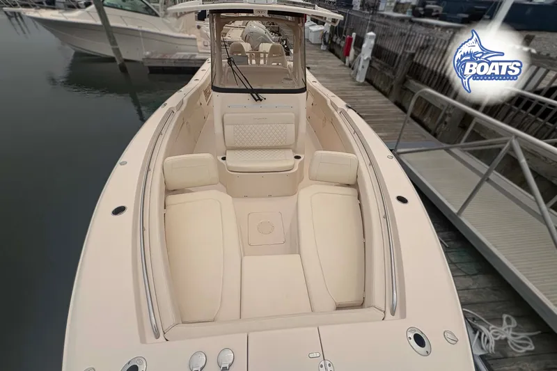 Slide: The Image of 2024 Grady-White Canyon 306 boat with spacious seating, docked at marina. - 4