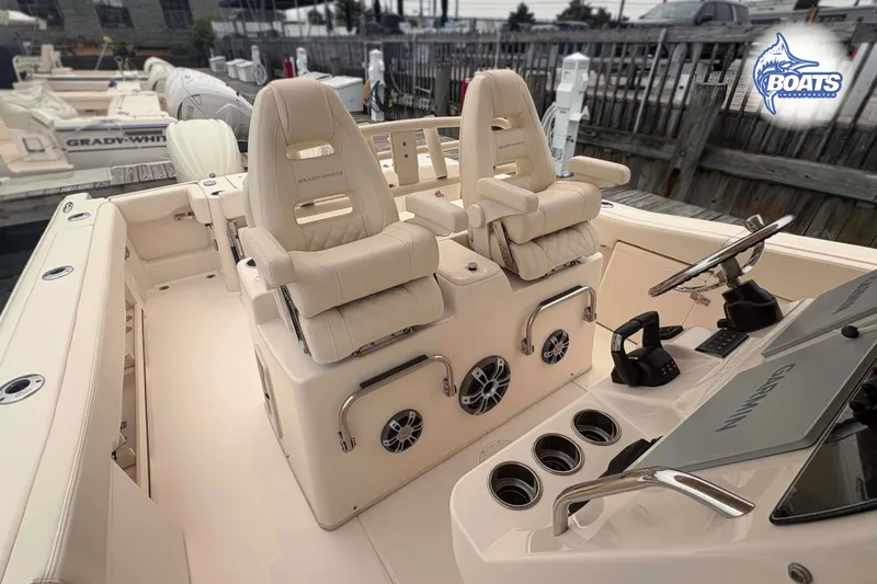 Slide: The Image of 2024 Grady-White Canyon 306 boat interior with helm, seating, and controls. - 6