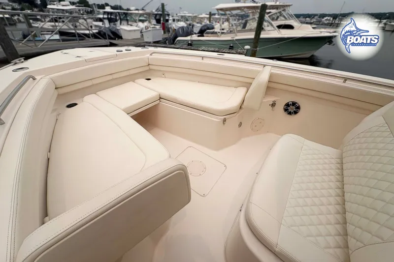 Slide: The Image of 2024 Grady-White Canyon 306 boat interior with luxurious seating at marina. - 5