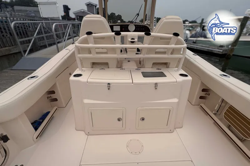 Slide: The Image of 2024 Grady-White Canyon 306 boat interior, featuring spacious seating and storage compartments. - 8