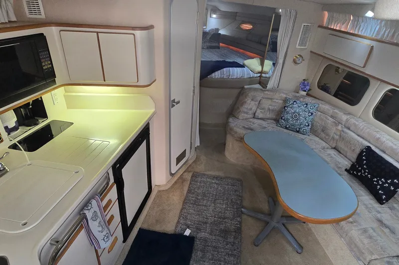 Slide: The Image of Interior of a 1994 Sea Ray 370 Express Cruiser with kitchen and seating area. - 20
