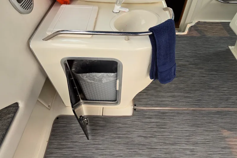 Slide: The Image of Interior of 1994 Sea Ray 370 Express Cruiser with sink and storage compartment. - 13