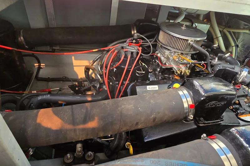 Slide: The Image of Engine compartment of a 1994 Sea Ray 370 Express Cruiser, showcasing mechanical components and wiring. - 36
