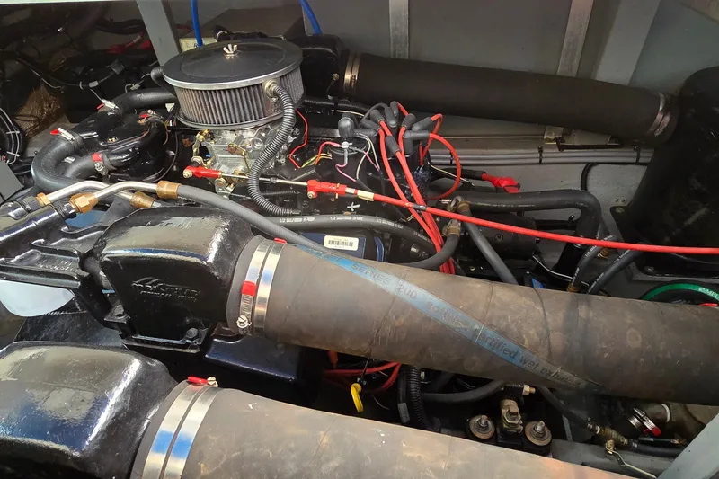Slide: The Image of Engine compartment of a 1994 Sea Ray 370 Express Cruiser with visible hoses and wiring. - 39