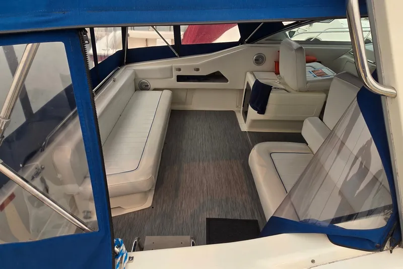 Slide: The Image of Interior of a 1994 Sea Ray 370 Express Cruiser with blue and white seating. - 7