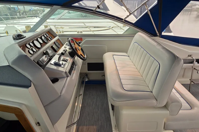 Slide: The Image of 1994 Sea Ray 370 Express Cruiser helm with steering wheel and seating. - 14