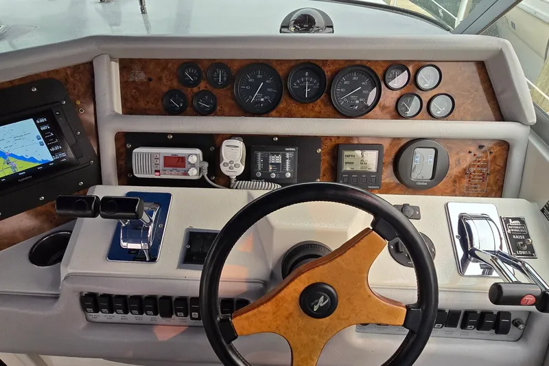 Slide: The Image of Dashboard of a 1994 Sea Ray 370 Express Cruiser with navigation and control instruments. - 17