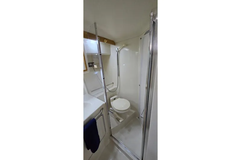 Slide: The Image of Bathroom interior of 1994 Sea Ray 370 Express Cruiser with shower and toilet. - 29