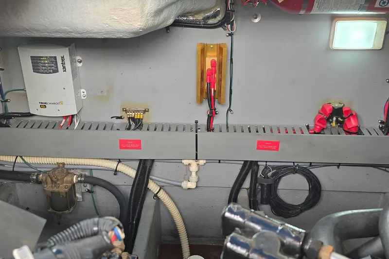 Slide: The Image of Engine room of a 1994 Sea Ray 370 Express Cruiser with electrical components and wiring. - 33