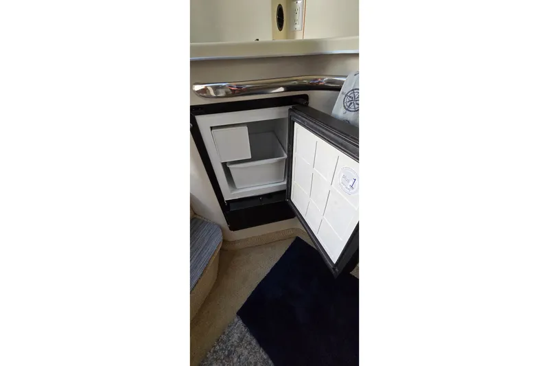 Slide: The Image of Open refrigerator inside a 1994 Sea Ray 370 Express Cruiser boat cabin. - 31