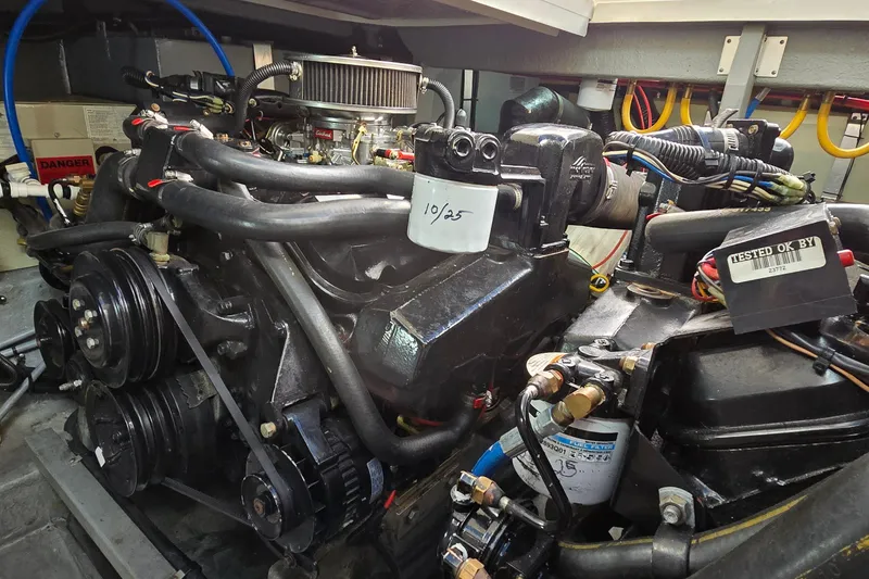 Slide: The Image of Engine compartment of a 1994 Sea Ray 370 Express Cruiser, showcasing mechanical components and wiring. - 37