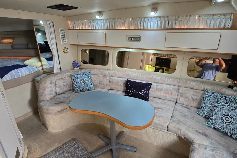 Slide: The Image of Interior of 1994 Sea Ray 370 Express Cruiser with cozy seating and modern decor. - 21