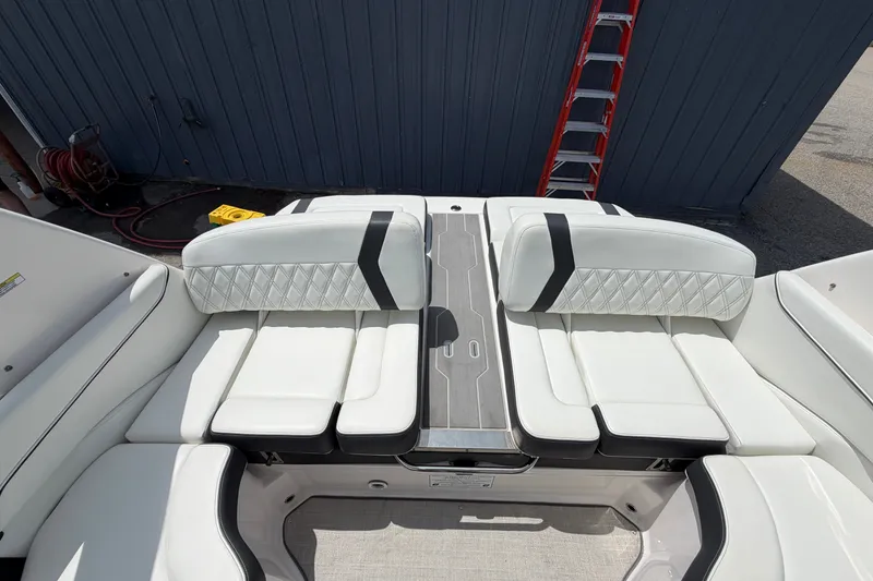 Slide: The Image of 2020 Regal 2300 Bowrider boat interior with white cushioned seating and modern design. - 5