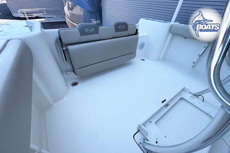 Slide: The Image of 2021 Key West 244 Center Console boat interior with foldable seating and Yamaha engine. - 10