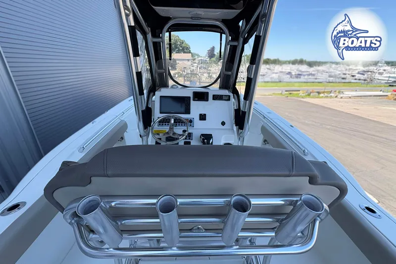 Slide: The Image of 2021 Key West 244 Center Console boat interior with steering wheel and rod holders. - 5