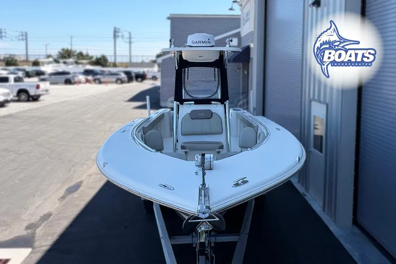 Slide: The Image of 2021 Key West 244 Center Console boat displayed outdoors near a building. - 2