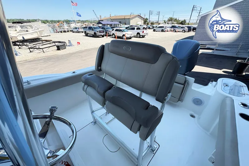Slide: The Image of 2021 Key West 244 Center Console boat interior with seating and steering wheel. - 7