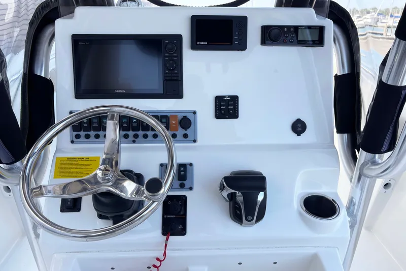 Slide: The Image of 2021 Key West 244 Center Console boat dashboard with steering wheel and navigation controls. - 6