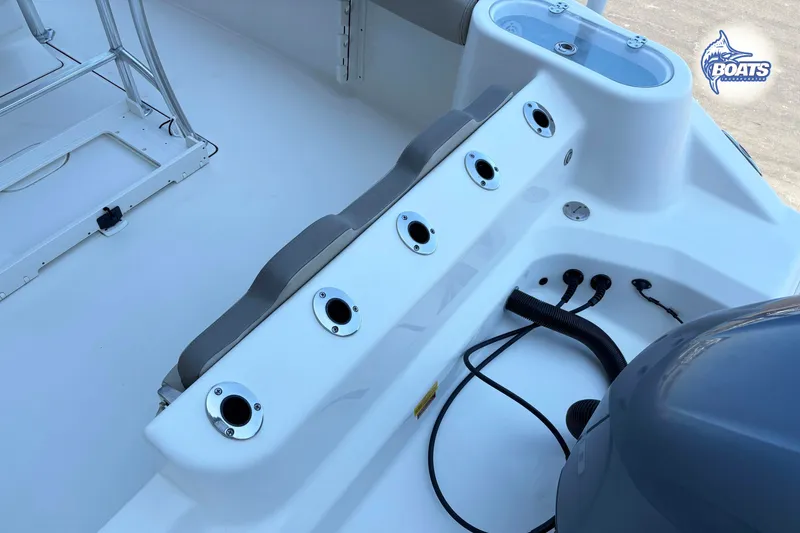 Slide: The Image of 2021 Key West 244 Center Console boat interior with rod holders and engine connections. - 11