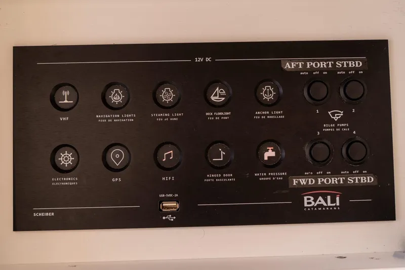 Slide: The Image of Control panel of a 2020 Bali 4.1 catamaran with various switches and indicators. - 29