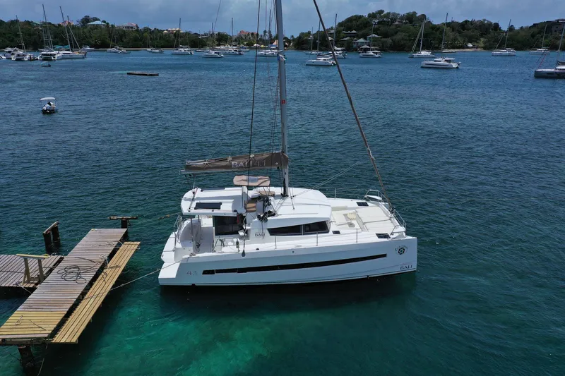 Slide: The Image of Aerial view of a 2020 Bali 4.1 catamaran docked in a serene marina. - 2