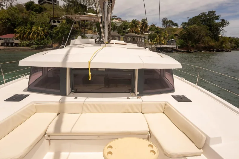 Slide: The Image of Luxury Bali 4.1 catamaran, 2020 model, docked near lush tropical shoreline. - 25