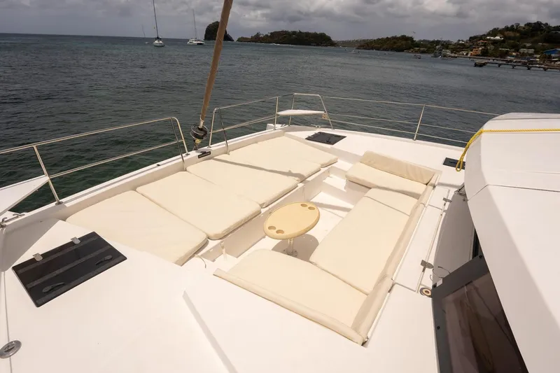 Slide: The Image of Luxurious Bali 4.1 catamaran deck with cushioned seating, 2020 model, overlooking serene waters. - 26