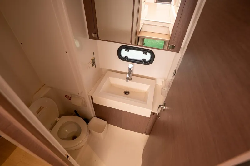 Slide: The Image of Compact bathroom in a 2020 Bali 4.1 model, featuring a sink and toilet. - 24