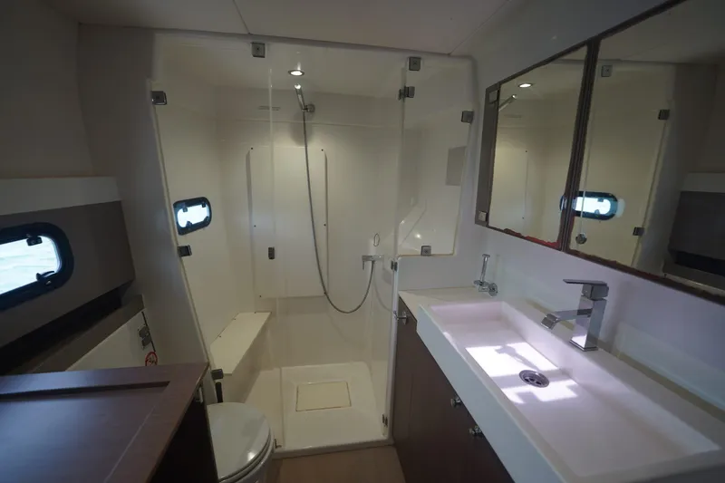 Slide: The Image of Modern bathroom interior in a 2020 Bali 4.1 yacht, featuring a shower, sink, and mirror. - 9