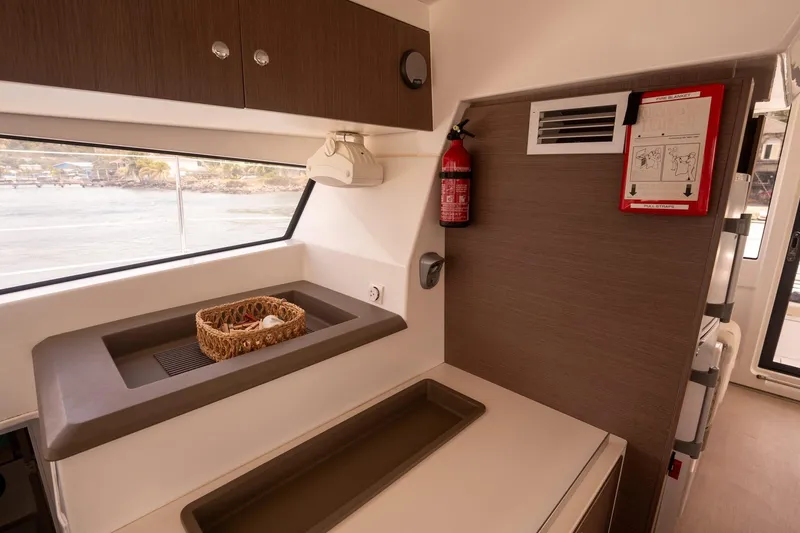 Slide: The Image of Modern kitchen area in a 2020 Bali 4.1 yacht, featuring a sink and fire safety equipment. - 14