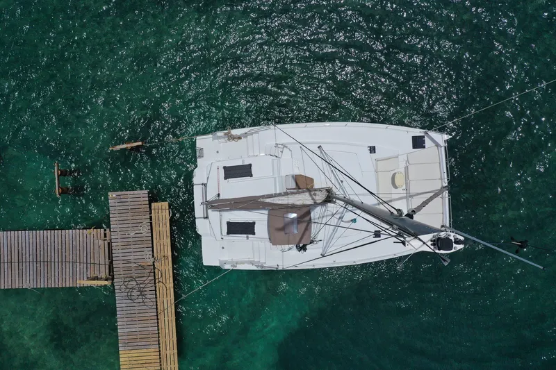 Slide: The Image of Aerial view of a 2020 Bali 4.1 catamaran docked on clear turquoise water. - 4