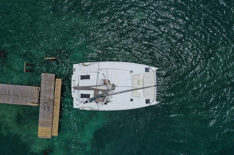 Slide: The Image of Aerial view of 2020 Bali 4.1 catamaran docked on clear turquoise water. - 3