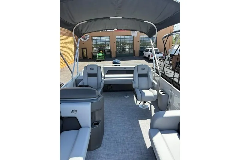 Slide: The Image of 2026 Sun Tracker Party Barge 22 RF DLX interior with seating and canopy. - 6