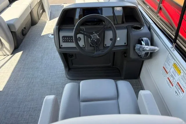 Slide: The Image of 2026 Sun Tracker Party Barge 22 RF DLX boat interior with steering console and seating. - 5