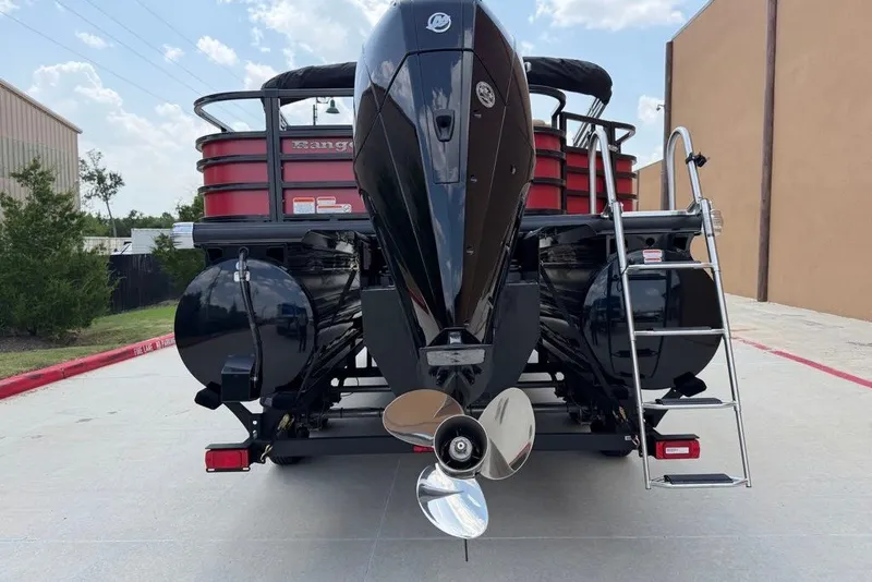 Slide: The Image of 2026 Ranger 223F boat rear view with motor and ladder on a sunny day. - 2