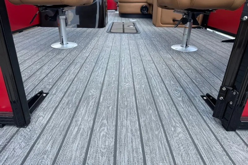 Slide: The Image of 2026 Ranger 223F boat interior with gray textured flooring and tan seats. - 11
