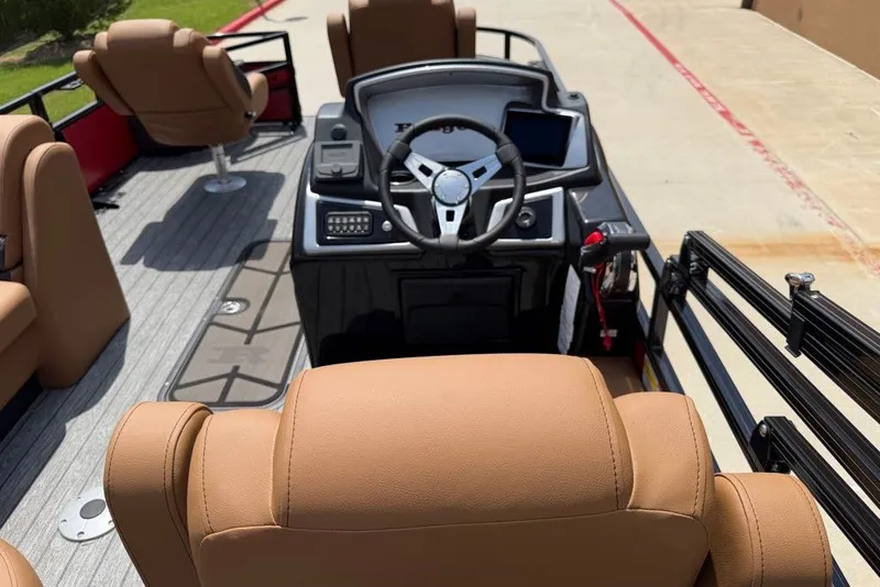 Slide: The Image of Interior of 2026 Ranger 223F boat with tan seats and modern steering console. - 10
