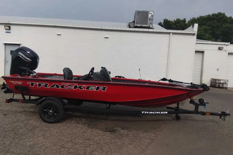 Slide: The Image of 2026 Tracker Pro Team 175 Crappie Edition boat, red, on trailer, parked outdoors. - 2