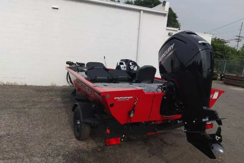Slide: The Image of 2026 Tracker Pro Team 175 Crappie Edition boat with Mercury engine, parked outdoors. - 9
