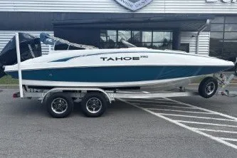 The Image of 2026 Tahoe 2150 boat on trailer, parked outside a building. - 0