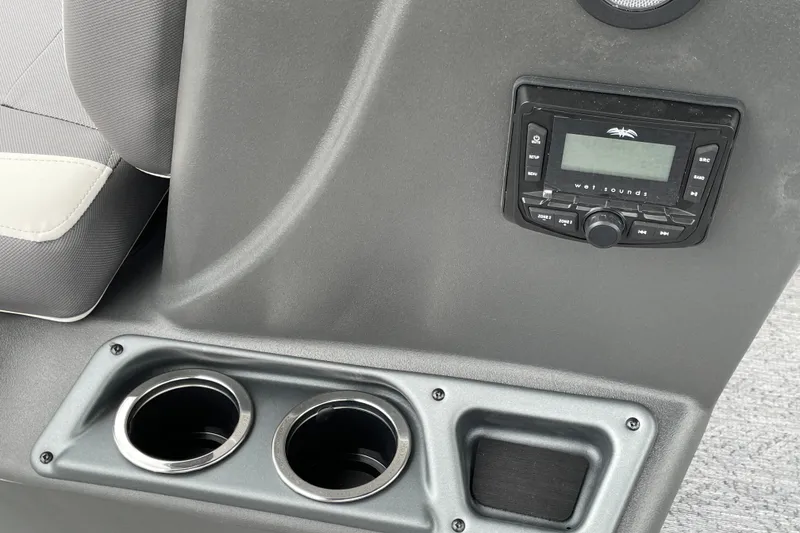 Slide: The Image of 2026 Sun Tracker Bass Buggy 18 DLX console with stereo system and cup holders. - 13