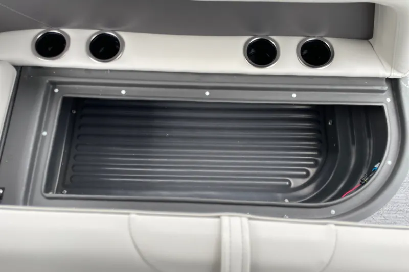 Slide: The Image of 2026 Sun Tracker Bass Buggy 18 DLX storage compartment with cup holders. - 22