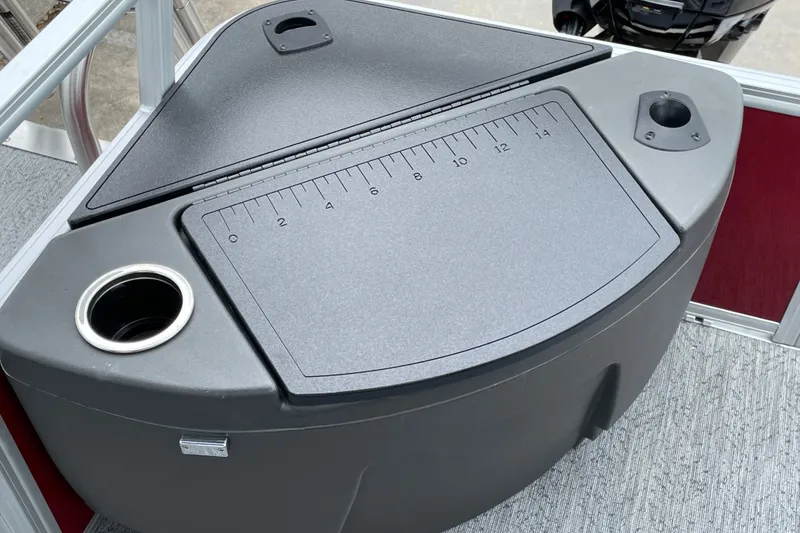 Slide: The Image of 2026 Sun Tracker Bass Buggy 18 DLX fishing station with integrated ruler and cup holders. - 18
