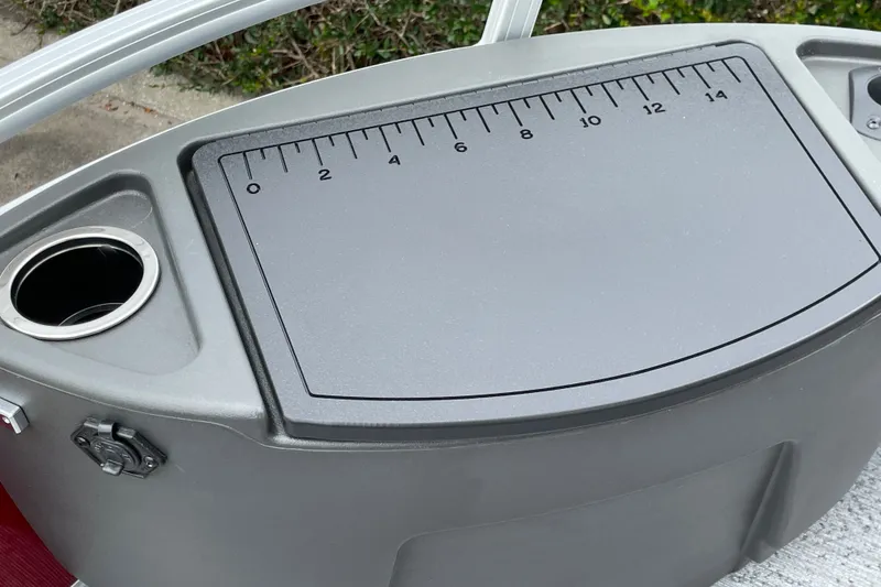 Slide: The Image of Sun Tracker Bass Buggy 18 DLX 2026 boat console with integrated ruler and cup holder. - 14
